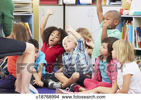 Picture - Group of Elementary Pupils In Classroom Answering Question. Fotosearch