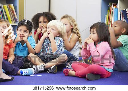 Stock Photograph - Group of Elementary Pupils In Classroom Touching Noses. Fotosearch