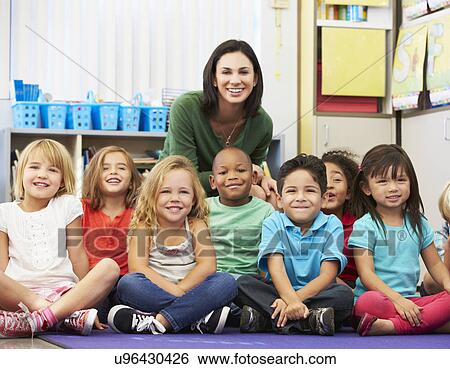 Group of Elementary Pupils In Classroom With Teacher View Large Photo Image Stock Photograph - Group of Elementary Pupils In Classroom With Teacher. Fotosearch