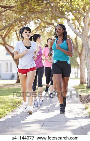 Group Of Female Runners Exercising On Suburban Street View Large Photo Image Stock Photo - Group Of Female Runners Exercising On Suburban Street. Fotosearch