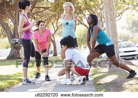 Stock Image - Group Of Female Runners Warming Up Before Run. Fotosearch
