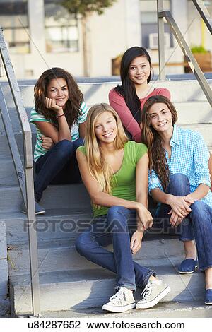 Stock Image - Group Of Female Teenage Pupils Outside Classroom. Fotosearch