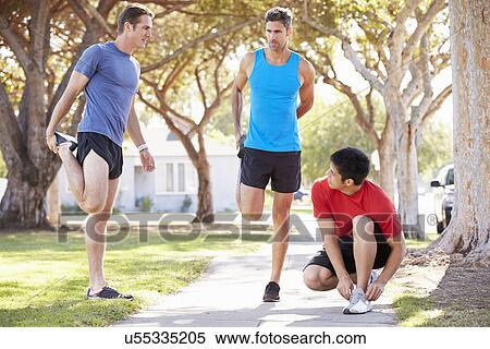 Stock Photography - Group Of Male Runners Warming Up Before Run. Fotosearch