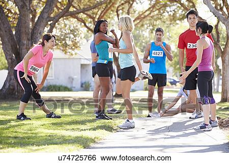Stock Photograph - Group Of Runners Warming Up Before Race. Fotosearch