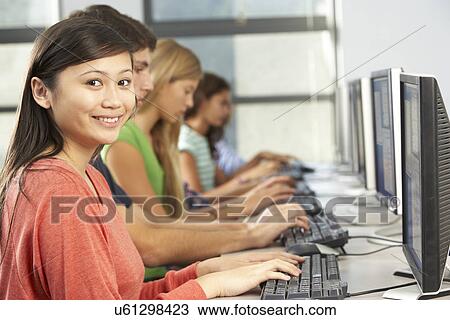 Stock Image - Group Of Students Working At Computers In Classroom. Fotosearch