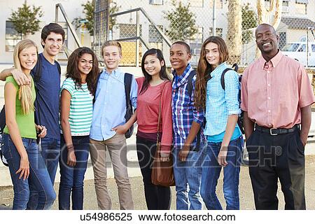 Stock Photography - Group Of Teenage Pupils With Teacher Outside Classroom . Fotosearch