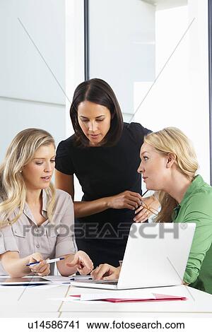 Stock Image - Group Of Women Meeting In Office. Fotosearch