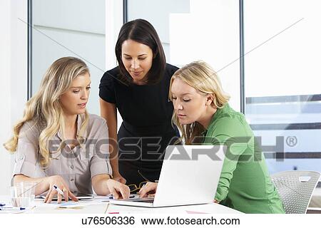 Stock Photograph - Group Of Women Meeting In Office. Fotosearch