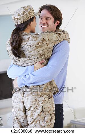Stock Photo - Husband Greeting Military Wife Home On Leave. Fotosearch