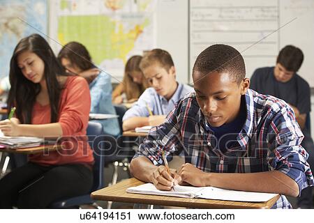 Male Pupil Studying At Desk In Classroom View Large Photo Image Stock Image - Male Pupil Studying At Desk In Classroom. Fotosearch