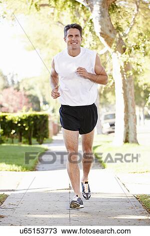 Male Runner Exercising On Suburban Street View Large Photo Image Stock Image - Male Runner Exercising On Suburban Street. Fotosearch