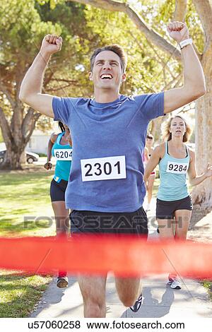 Stock Photo - Male Runner Winning Marathon. Fotosearch