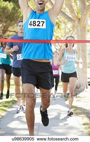 Stock Photography - Male Runner Winning Marathon. Fotosearch