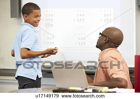Stock Photo - Male Student Writing Answer On Whiteboard. Fotosearch