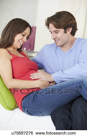 Man Relaxing On Sofa With Pregnant Wife At Home View Large Photo Image Stock Photograph - Man Relaxing On Sofa With Pregnant Wife At Home. Fotosearch