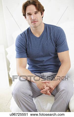 Man Sitting On Bed Wearing Pajamas View Large Photo Image Stock Image - Man Sitting On Bed Wearing Pajamas. Fotosearch