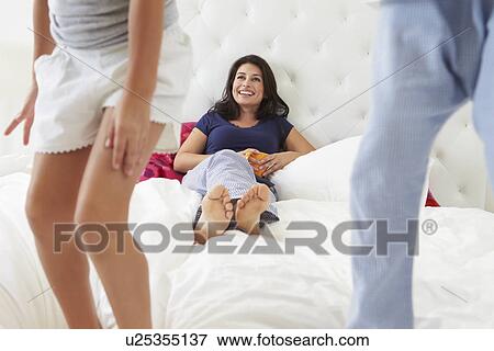 Mother And Children Relaxing In Bed Wearing Pajamas View Large Photo Image Stock Photo - Mother And Children Relaxing In Bed Wearing Pajamas. Fotosearch