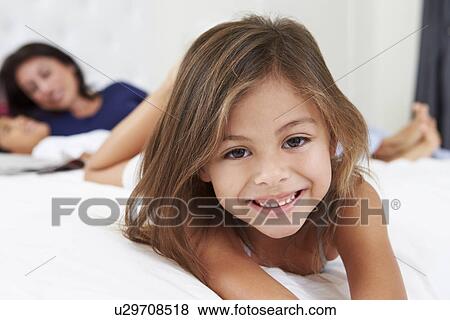 Mother And Children Relaxing In Bed Wearing Pajamas View Large Photo Image Stock Photo - Mother And Children Relaxing In Bed Wearing Pajamas. Fotosearch