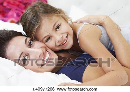 Mother And Daughter Lying In Bed Together View Large Photo Image Stock Photograph - Mother And Daughter Lying In Bed Together. Fotosearch