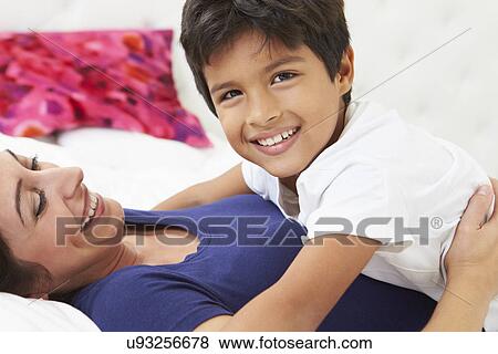 Mother And Son Lying In Bed Together View Large Photo Image Stock Photo - Mother And Son Lying In Bed Together. Fotosearch