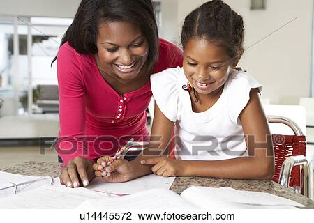Mother Helping Daughter With Homework In Kitchen View Large Photo Image Stock Image - Mother Helping Daughter With Homework In Kitchen. Fotosearch