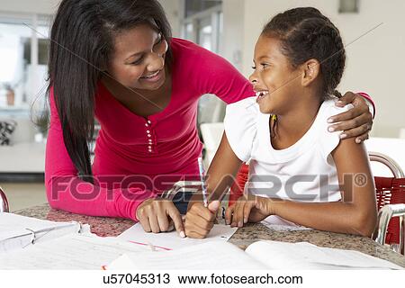 Mother Helping Daughter With Homework In Kitchen View Large Photo Image Stock Image - Mother Helping Daughter With Homework In Kitchen. Fotosearch