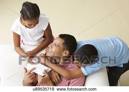 Overhead View Of Children Giving Father Gift View Large Photo Image Stock Photo - Overhead View Of Children Giving Father Gift. Fotosearch