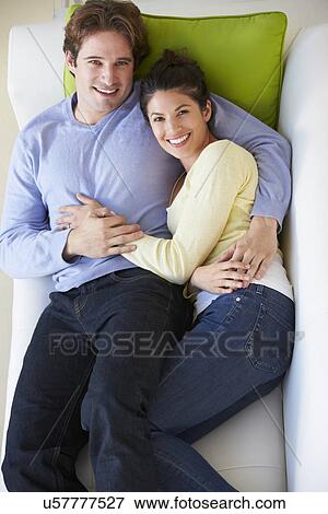 Overhead View Of Couple Relaxing On Sofa View Large Photo Image Stock Photo - Overhead View Of Couple Relaxing On Sofa. Fotosearch