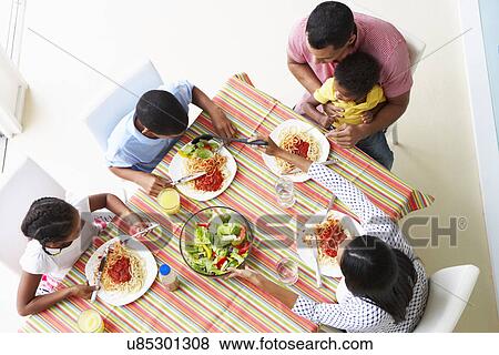 Overhead View Of Family Eating Meal Together View Large Photo Image Stock Photo - Overhead View Of Family Eating Meal Together. Fotosearch