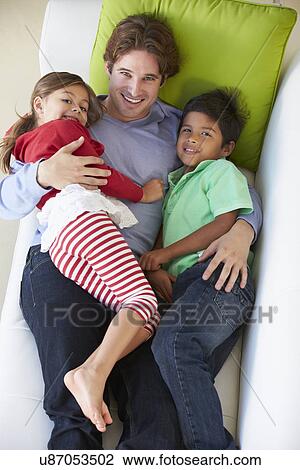 Overhead View Of Father And Children Relaxing On Sofa View Large Photo Image Stock Image - Overhead View Of Father And Children Relaxing On Sofa. Fotosearch
