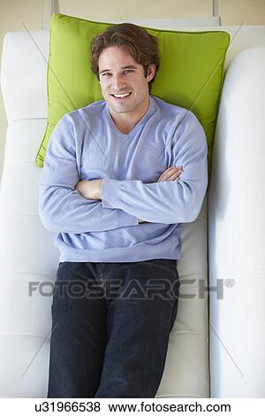 Overhead View Of Man Relaxing On Sofa View Large Photo Image Stock Photo - Overhead View Of Man Relaxing On Sofa. Fotosearch