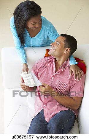 Stock Photo - Overhead View Of Woman Giving Man Gift. Fotosearch