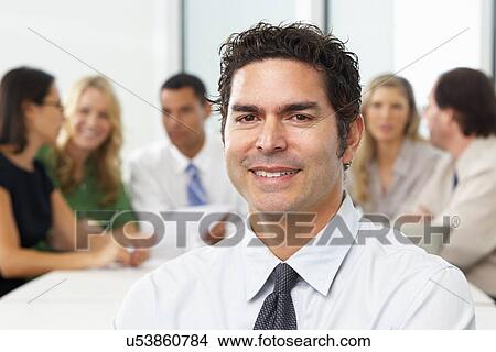 Portrait Of Businessman Sitting At Boardroom Table View Large Photo Image Picture - Portrait Of Businessman Sitting At Boardroom Table. Fotosearch