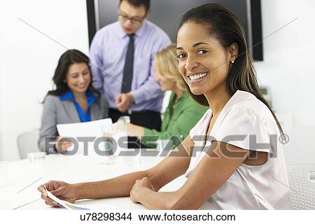 Portrait Of Businesswoman In Boardroom With Colleagues View Large Photo Image Picture - Portrait Of Businesswoman In Boardroom With Colleagues. Fotosearch