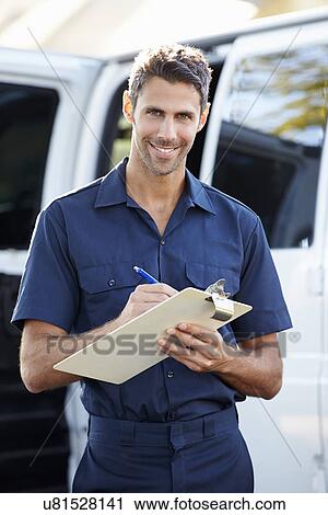 Stock Image - Portrait Of Delivery Driver With Clipboard. Fotosearch