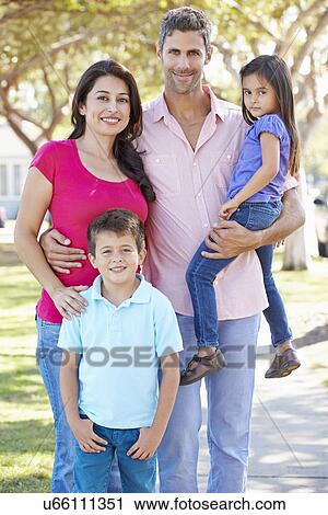 Stock Image - Portrait Of Family On Suburban Street. Fotosearch