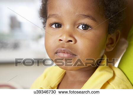 Stock Image - Portrait Of Happy Young Boy At Home. Fotosearch