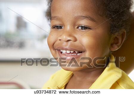 Stock Image - Portrait Of Happy Young Boy At Home. Fotosearch