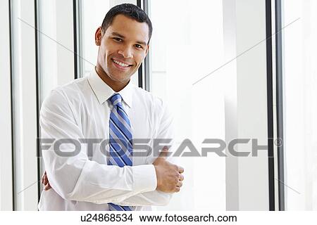 Portrait Of Smiling Businessman In Office View Large Photo Image Picture - Portrait Of Smiling Businessman In Office. Fotosearch