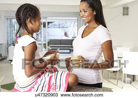 Pregnant Mother And Daughter Drinking Juice In Kitchen View Large Photo Image Stock Image - Pregnant Mother And Daughter Drinking Juice In Kitchen. Fotosearch