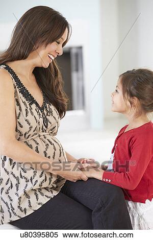 Stock Photography - Pregnant Mother With Daughter At Home. Fotosearch