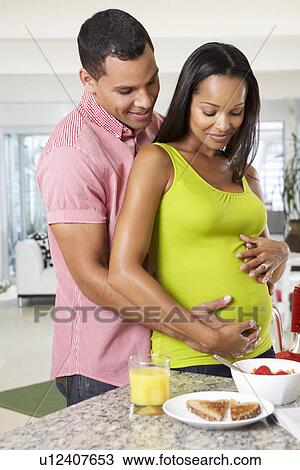 Pregnant Woman And Husband Having Breakfast In Kitchen View Large Photo Image Stock Image - Pregnant Woman And Husband Having Breakfast In Kitchen. Fotosearch