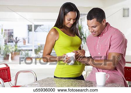 Pregnant Woman And Husband Having Breakfast In Kitchen View Large Photo Image Stock Image - Pregnant Woman And Husband Having Breakfast In Kitchen. Fotosearch