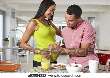 Pregnant Woman And Husband Having Breakfast In Kitchen View Large Photo Image Stock Image - Pregnant Woman And Husband Having Breakfast In Kitchen. Fotosearch