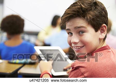 Stock Photography - Pupil In Class Using Digital Tablet. Fotosearch