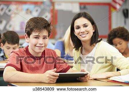 Pupils In Class Using Digital Tablet With Teacher View Large Photo Image Stock Photo - Pupils In Class Using Digital Tablet With Teacher. Fotosearch