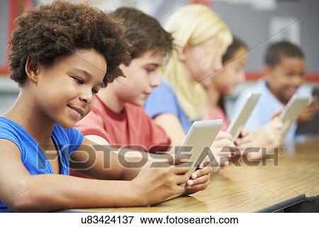 Pupils In Class Using Digital Tablet View Large Photo Image Stock Photo - Pupils In Class Using Digital Tablet. Fotosearch
