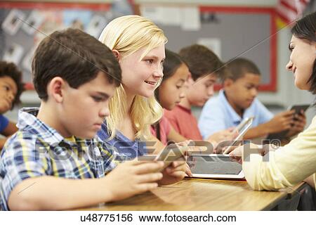 Pupils In Class Using Digital Tablet With Teacher View Large Photo Image Stock Photograph - Pupils In Class Using Digital Tablet With Teacher. Fotosearch