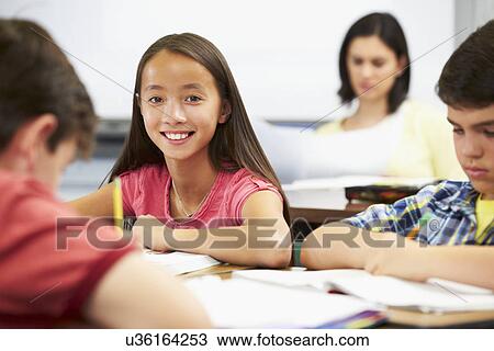 Pupils Studying At Desks In Classroom View Large Photo Image Stock Image - Pupils Studying At Desks In Classroom. Fotosearch