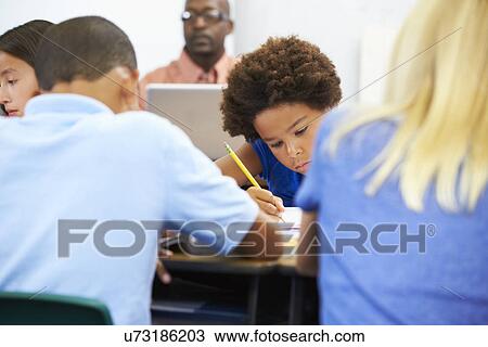Pupils Studying At Desks In Classroom View Large Photo Image Stock Image - Pupils Studying At Desks In Classroom. Fotosearch